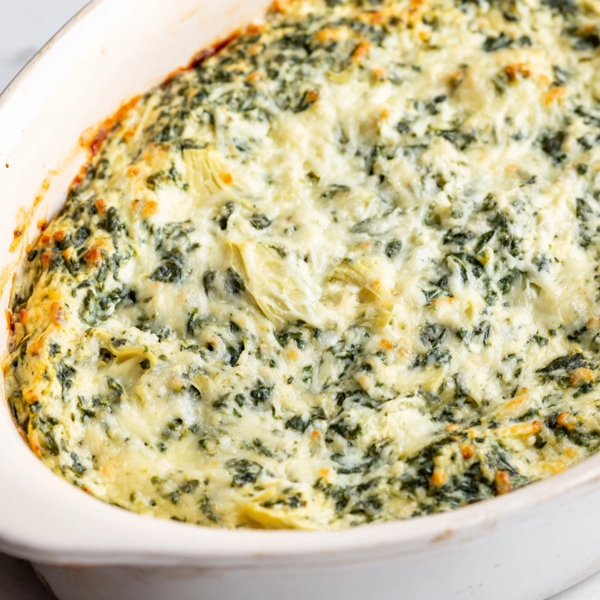 Warm and cheesy Spinach Artichoke Dip, served alongside toasted bread and crispy crackers, tempting!
