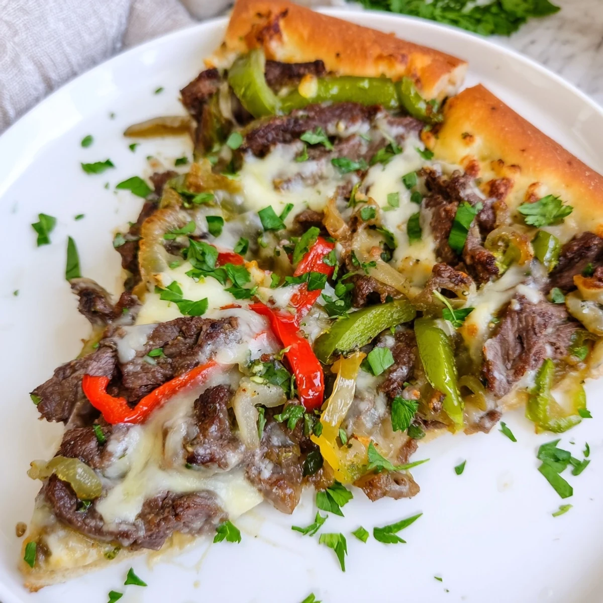 Golden Philly Cheesesteak Pizza featuring savory steak, peppers, onions, and melted cheese, perfect for dinner.