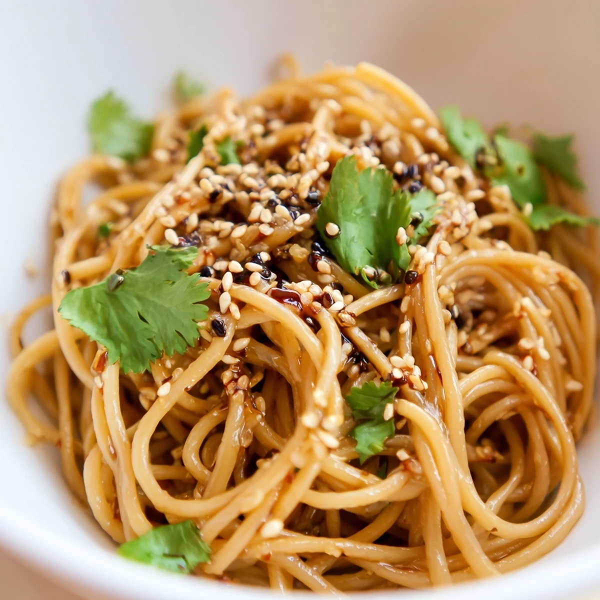 Chilled noodles coated in a bold sesame-soy-chili dressing, garnished with julienned cucumber and fresh cilantro.  