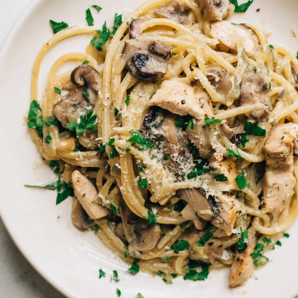 Creamy Mushroom Chicken Spaghettini features tender sliced chicken and al dente pasta coated in a velvety mushroom cream sauce.  