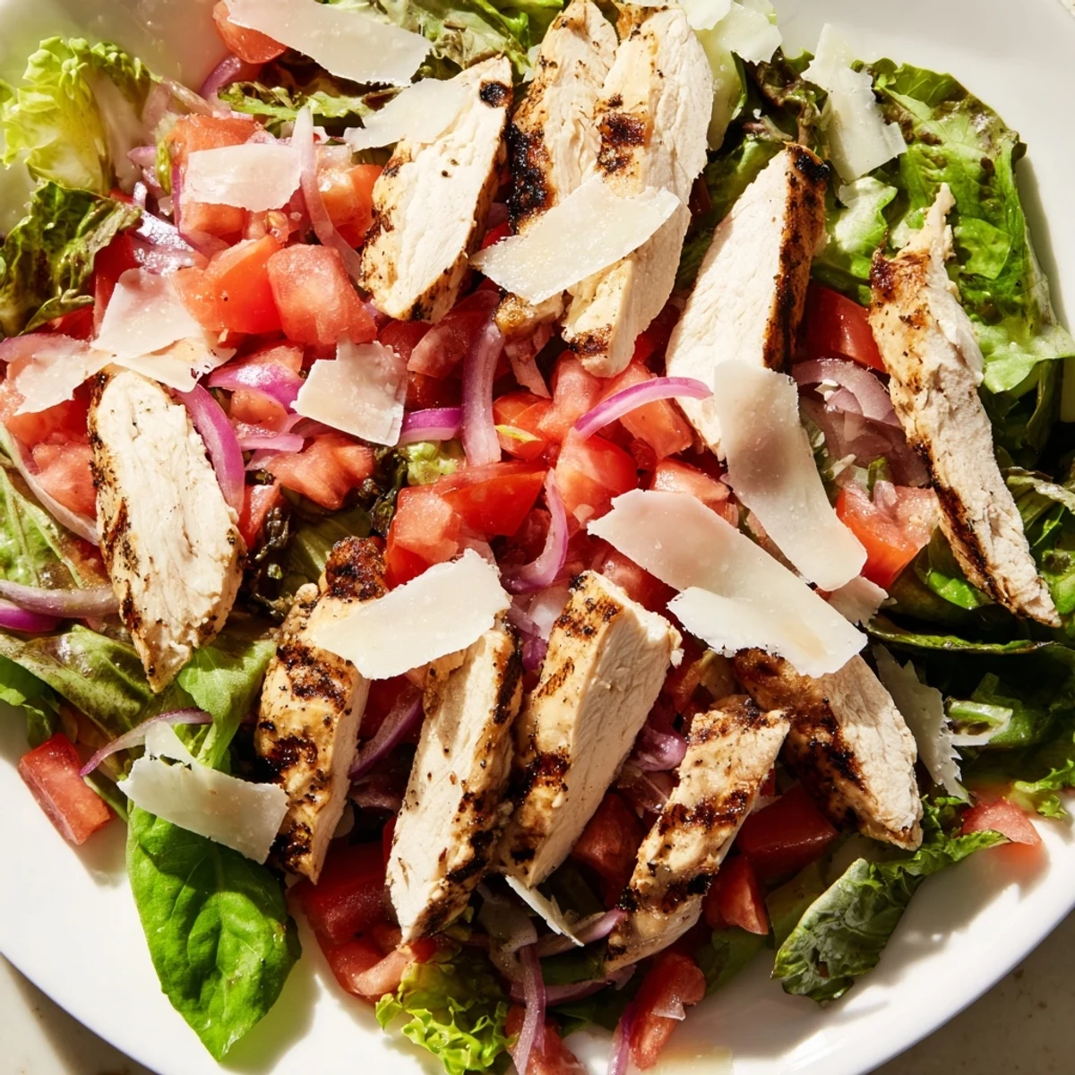Close-up of Bruschetta Chicken Salad with glistening olive oil and balsamic glaze, perfect for a light low-carb summer dinner.