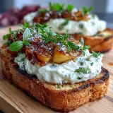 Creamy burrata and sweet honey-glazed peaches on rustic sourdough toast, perfect for a fresh spring brunch.  