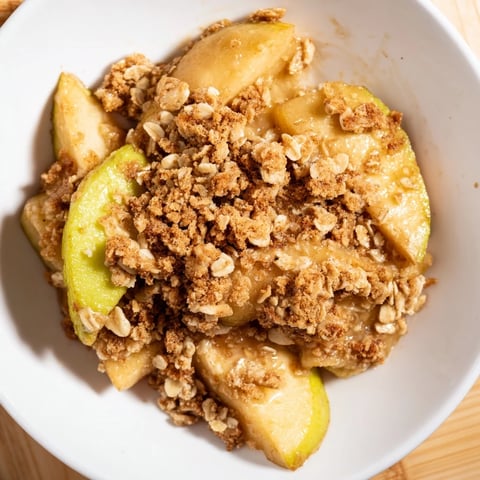 Warm, bubbly Apple Crumble with a crisp, golden topping, ready to serve with ice cream.