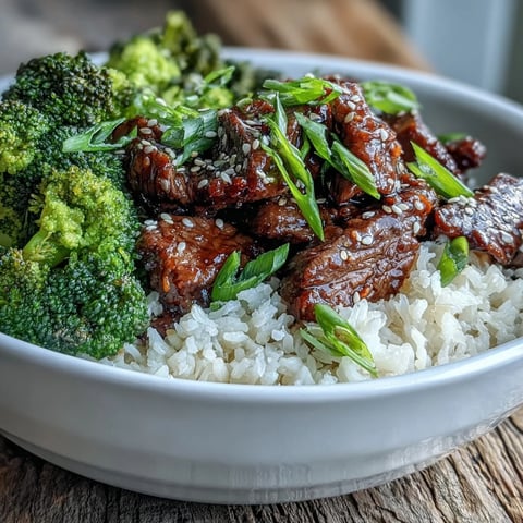 Tender beef strips and vibrant steamed broccoli nestle over fluffy jasmine rice in this Beef and Broccoli Bowl.  