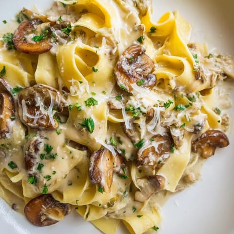 A close-up of Creamy Mushroom Alfredo pasta, featuring golden sautéed mushrooms and a rich, velvety sauce.  