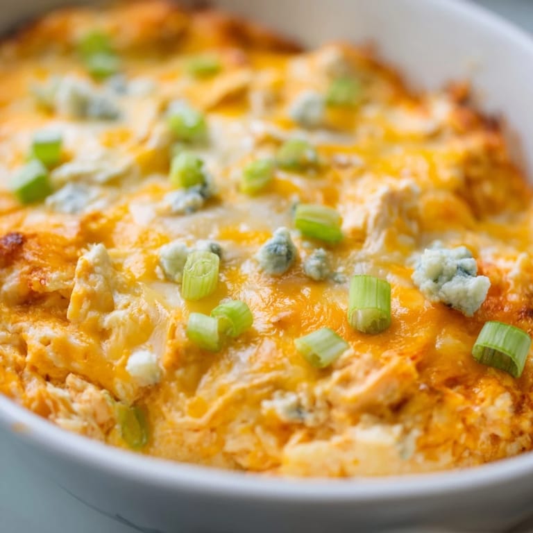 Close-up of a creamy, cheesy Buffalo Chicken Dip, ready for a game day appetizer spread.