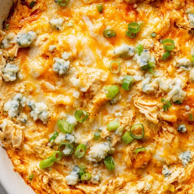 Hot and flavorful Buffalo Chicken Dip, perfect baked with melted cheese, for sharing with friends.