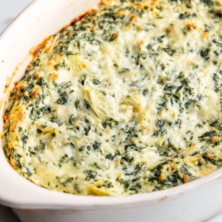 Warm and cheesy Spinach Artichoke Dip, served alongside toasted bread and crispy crackers, tempting!