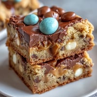 A pan of soft peanut butter Easter egg cookie bars with colorful candies on top, baked golden and ready to slice.